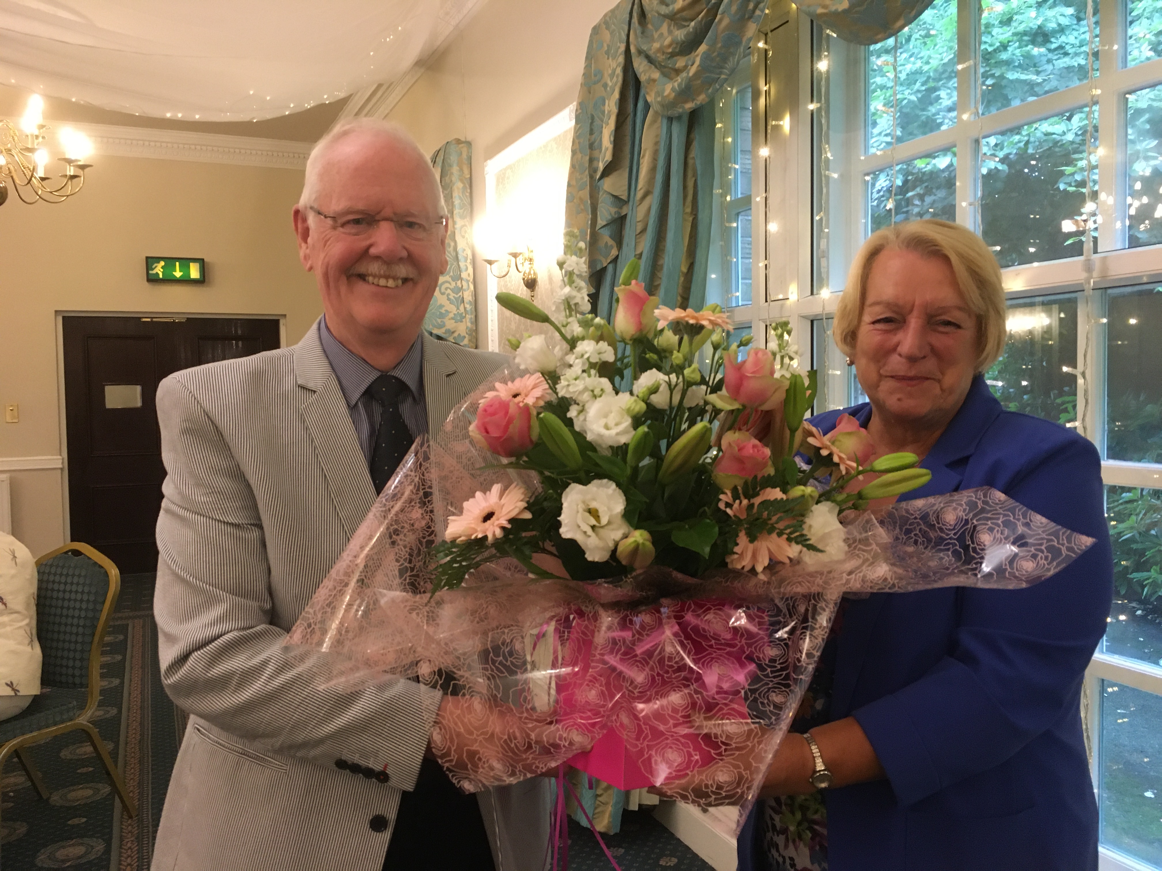 President Jack presents a bouquet to Pauline Critchley.